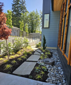 Landscape detail with basalt basin, flagstone path, and low plantings